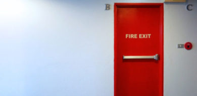 Fire exit emergency door red color metal material.